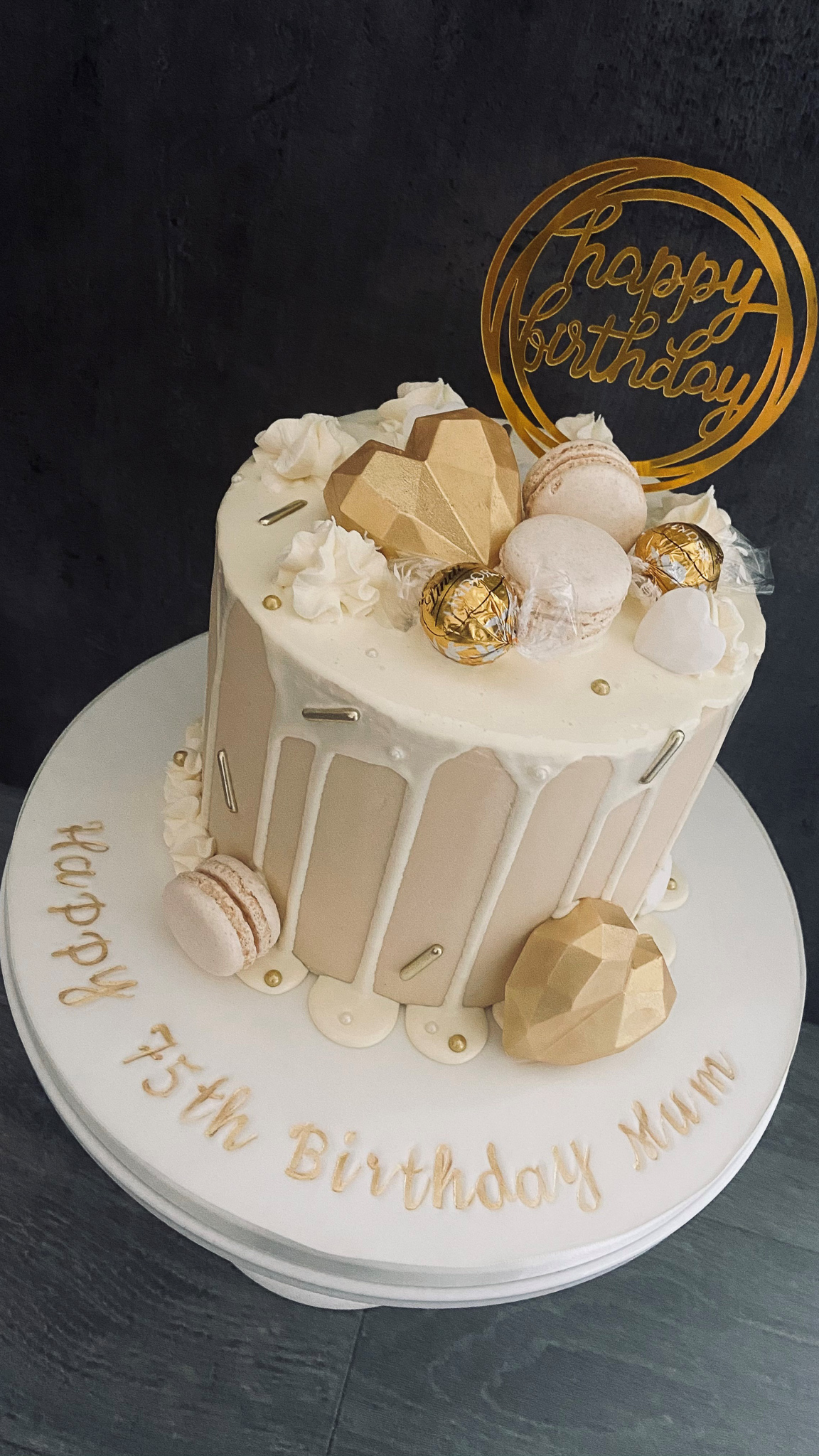 Luxury buttercreame drip cake with macarons and chocolate cake hearts