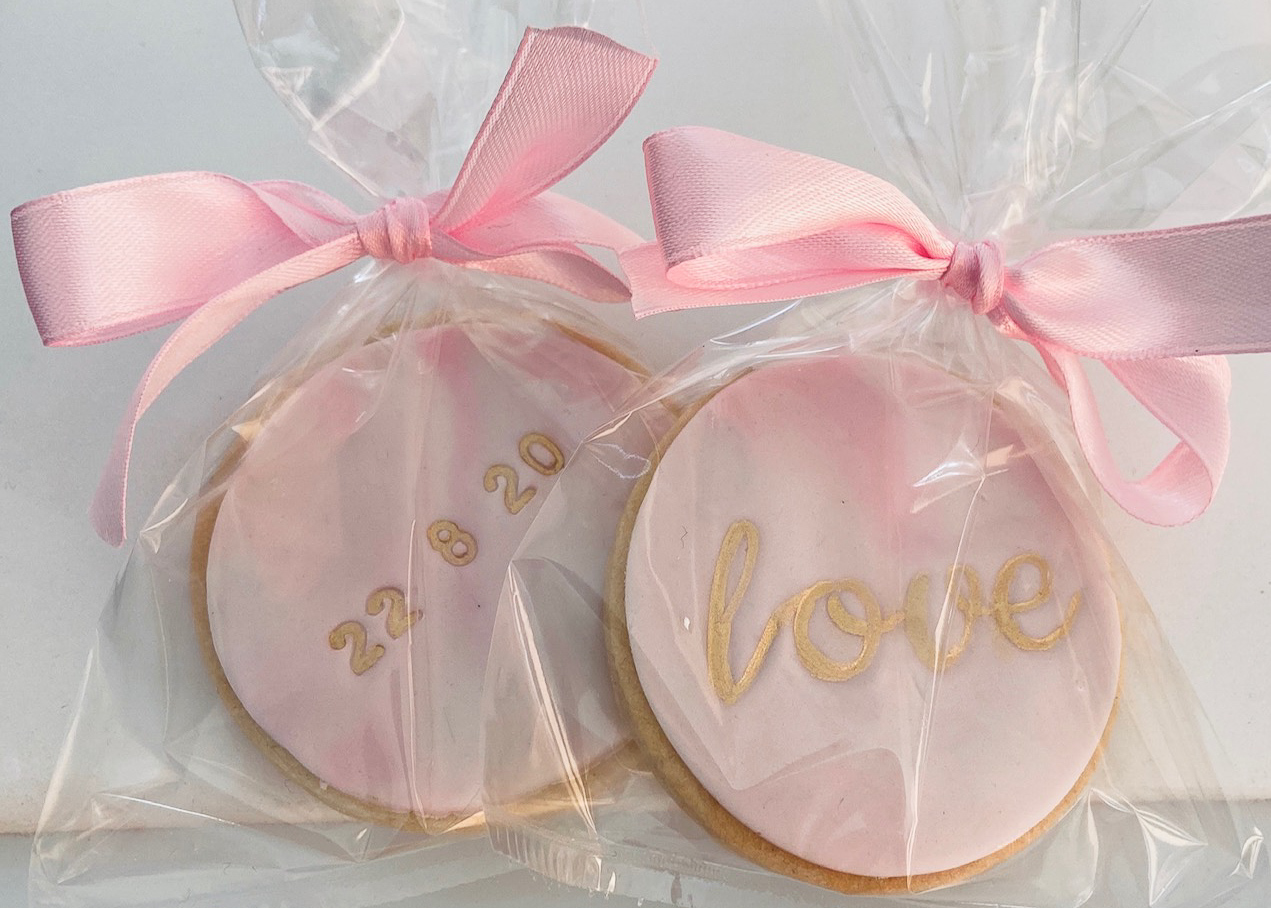 Pink marbled iced biscuit wedding favours