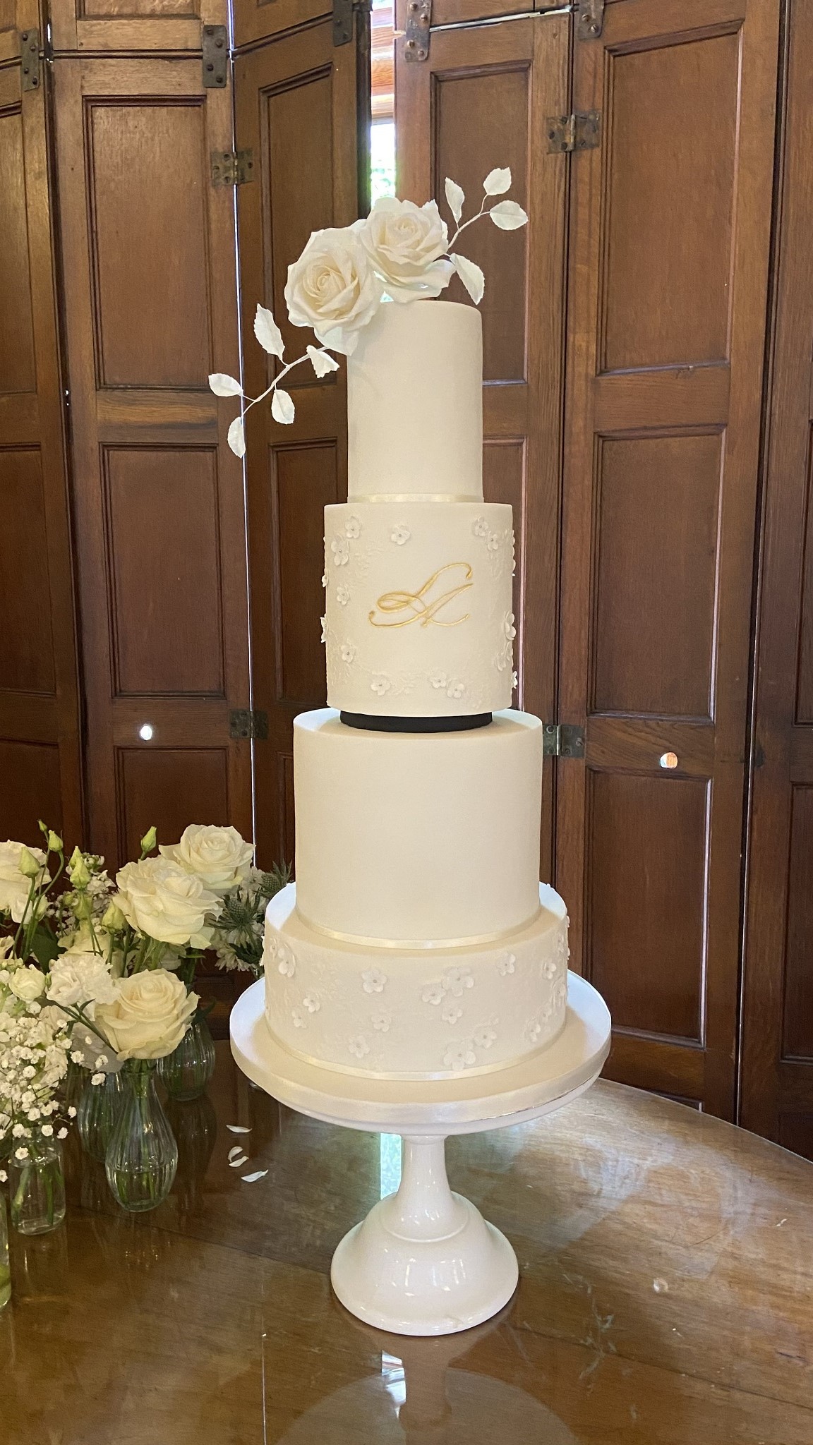 Luxury bespoke four tiers wedding cake design white black Drumtochty Castle Aberdeenshire Scotland