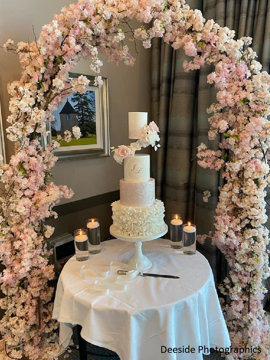 luxury wedding cake floating tier sugar flowers floral arch Meldrum House Aberdeenshire Scotland